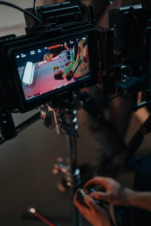 a close up of a camera on a tripod, video art, red and cinematic lighting, lcd screen, pictured from the shoulders up, on set