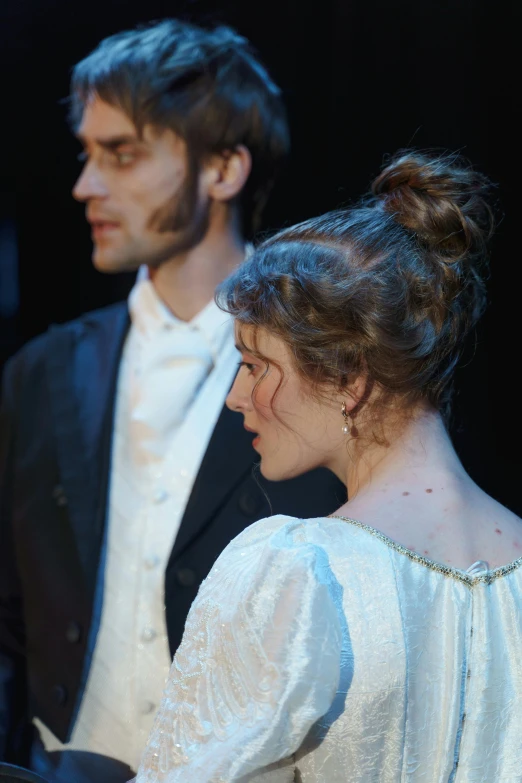 a man and a woman standing next to each other, by Sophie Pemberton, sideburns, dim lighting, [ theatrical ], jane austen