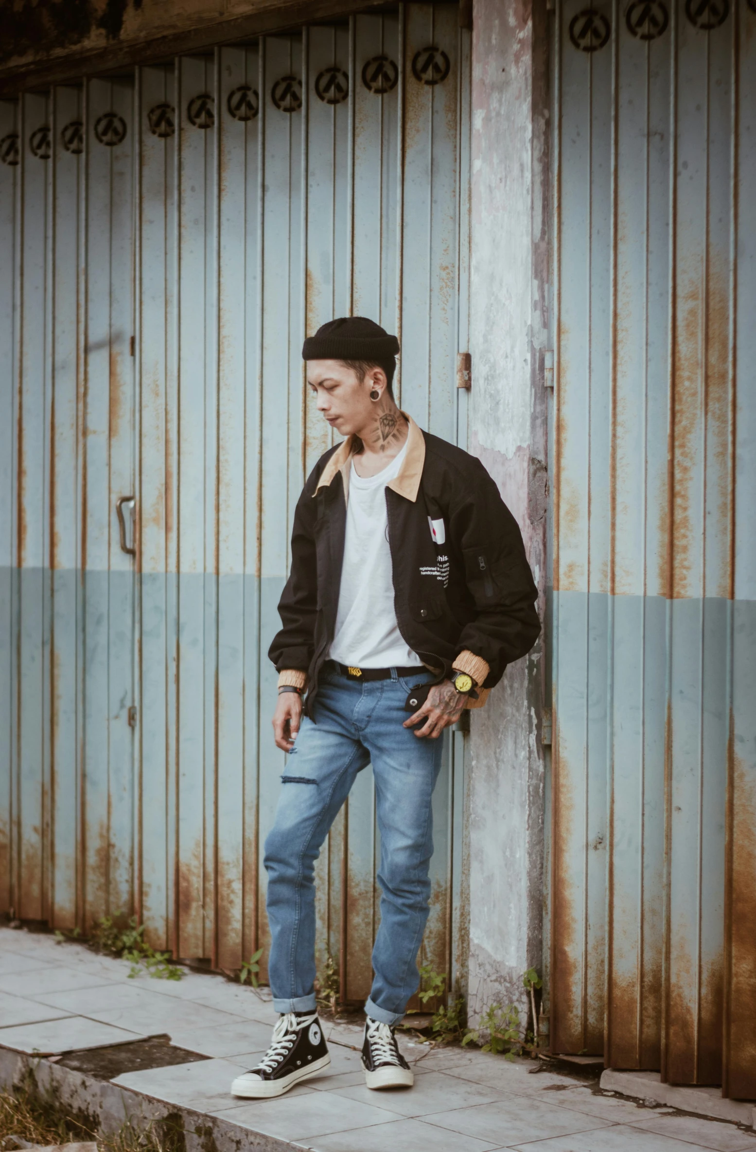 a man leaning against a wall with his hands in his pockets, a picture, inspired by Gang Hui-an, trending on pexels, neo-dada, bomber jacket, ulzzang, vintage pilot clothing, 15081959 21121991 01012000 4k