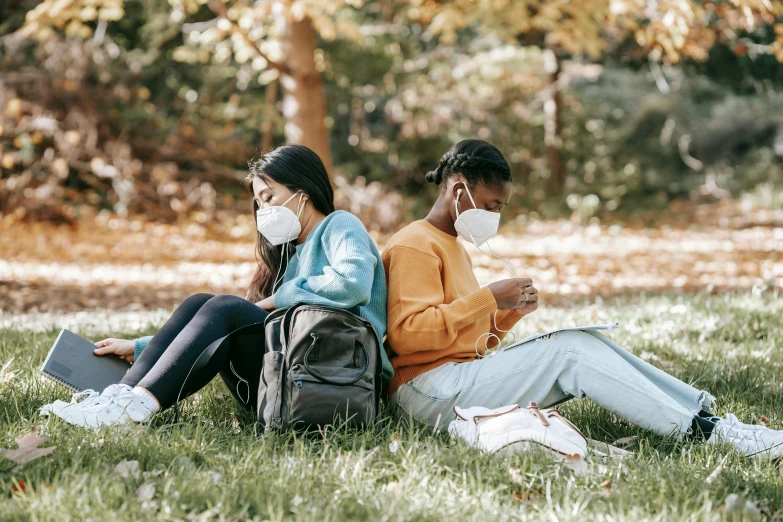 a couple of people that are sitting in the grass, trending on pexels, happening, medical mask, school, avatar image, phone