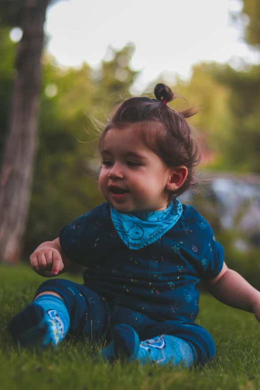 a little girl that is sitting in the grass, bandana, teal color graded, 8k 50mm iso 10, toddler