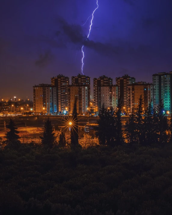 a lightning bolt over a city at night, a colorized photo, pexels contest winner, bisexual lighting, ominous photo, magical soviet town, ilustration