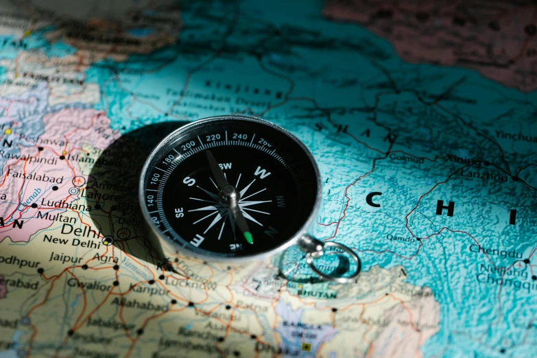 a compass sitting on top of a map, tehran, photo of the middle of the ocean, 🚿🗝📝