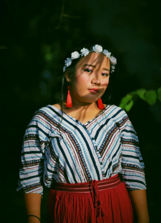 a woman with a flower in her hair, a portrait, inspired by Ruth Jên, pexels contest winner, sumatraism, patterned clothing, wearing a white folkdrakt dress, striped, avatar image