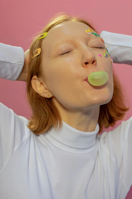 a woman taking a bubble out of her mouth, inspired by Ren Hang, trending on pexels, made out of sweets, pale green glow, polish hyper - casual, low quality photo