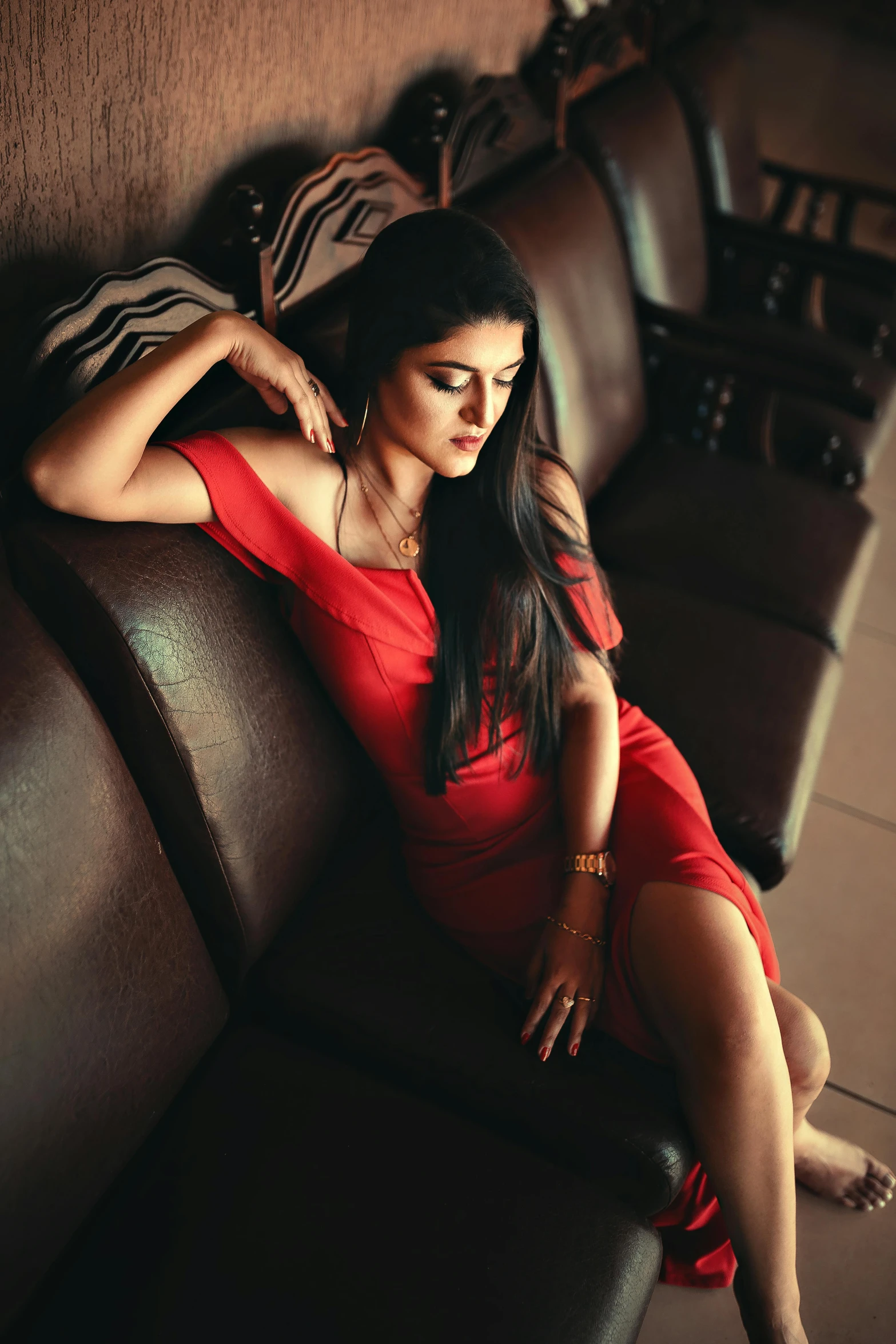 a woman in a red dress sitting on a couch, by Max Dauthendey, pexels contest winner, girl with black hair, provocative indian, a handsome, an elegant