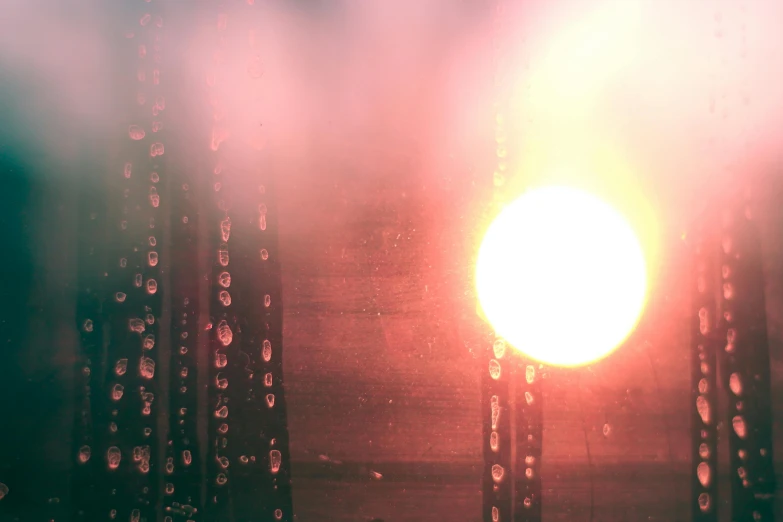 the sun is shining through the rain covered window, an album cover, inspired by Elsa Bleda, unsplash, light and space, red fog, illuminated orbs, atmospheric lighting - n 9, volumetric evening lights