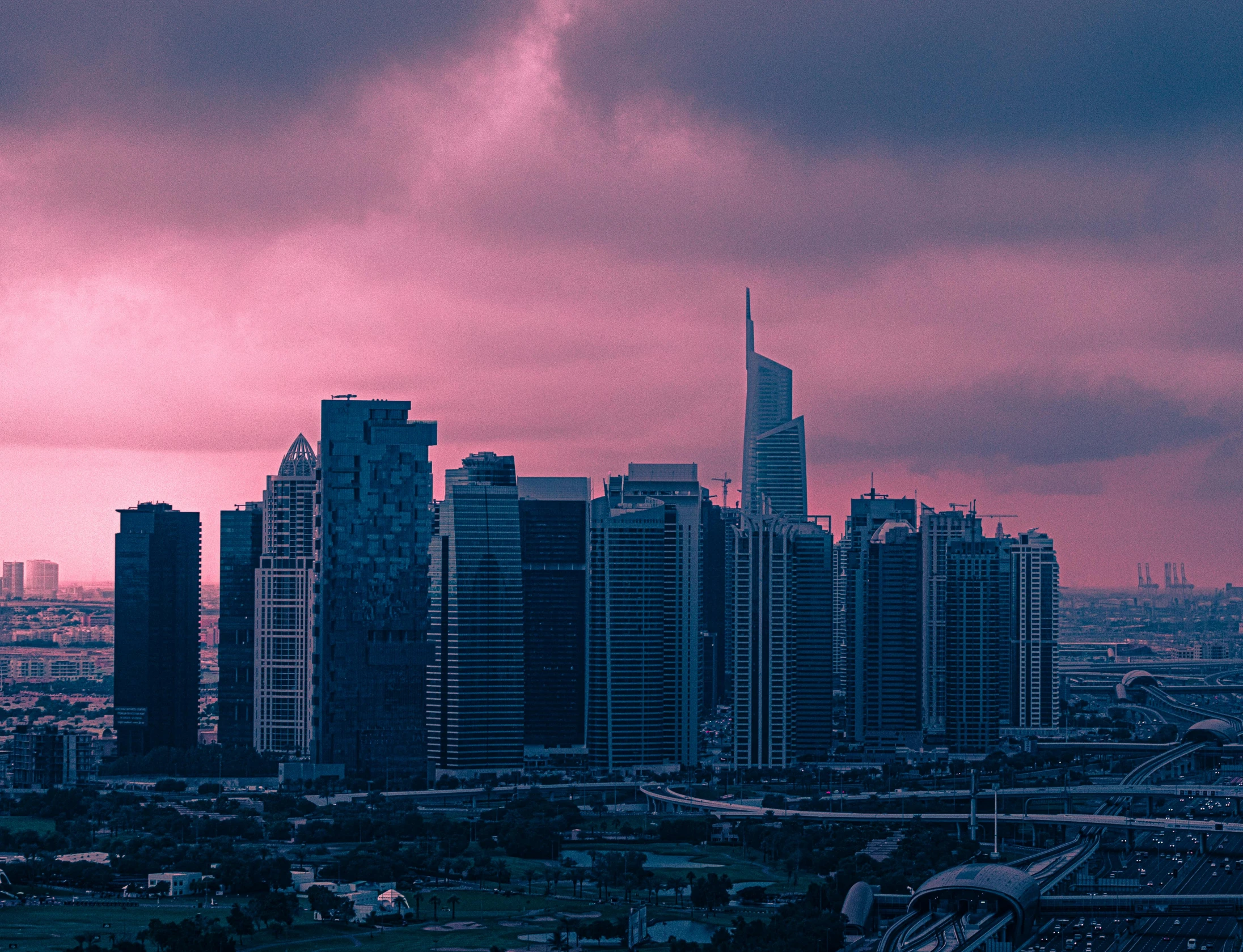 a view of a city from the top of a hill, pexels contest winner, surrealism, pink storm clouds, gta : dubai, synthwave image, overcast dusk