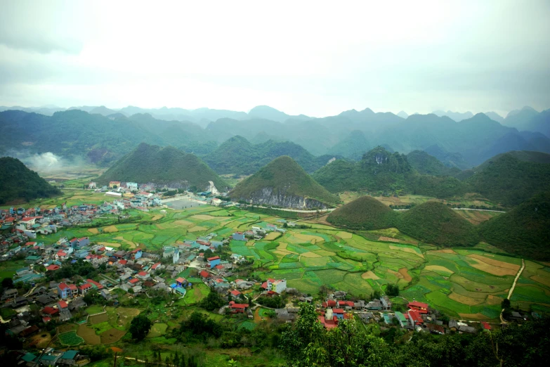 an aerial view of a village in the mountains, pexels contest winner, happening, ao dai, avatar image, square, limestone