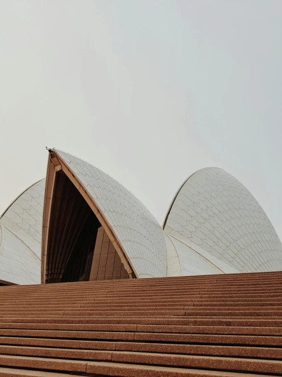 a man riding a skateboard down a flight of stairs, inspired by Sydney Carline, pexels contest winner, modernism, sydney opera house, tent architecture, background image