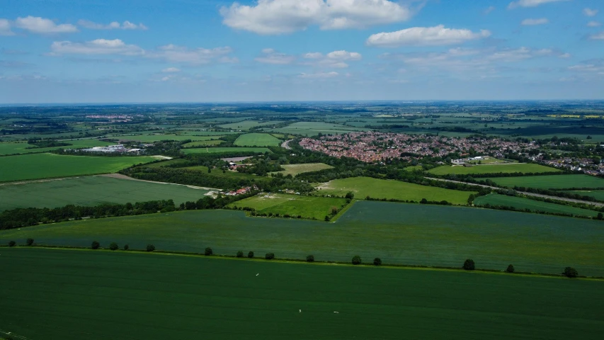 a view of the countryside from an airplane, by Julian Allen, unsplash, chesterfield, high polygon, panorama of crooked ancient city, low angle view