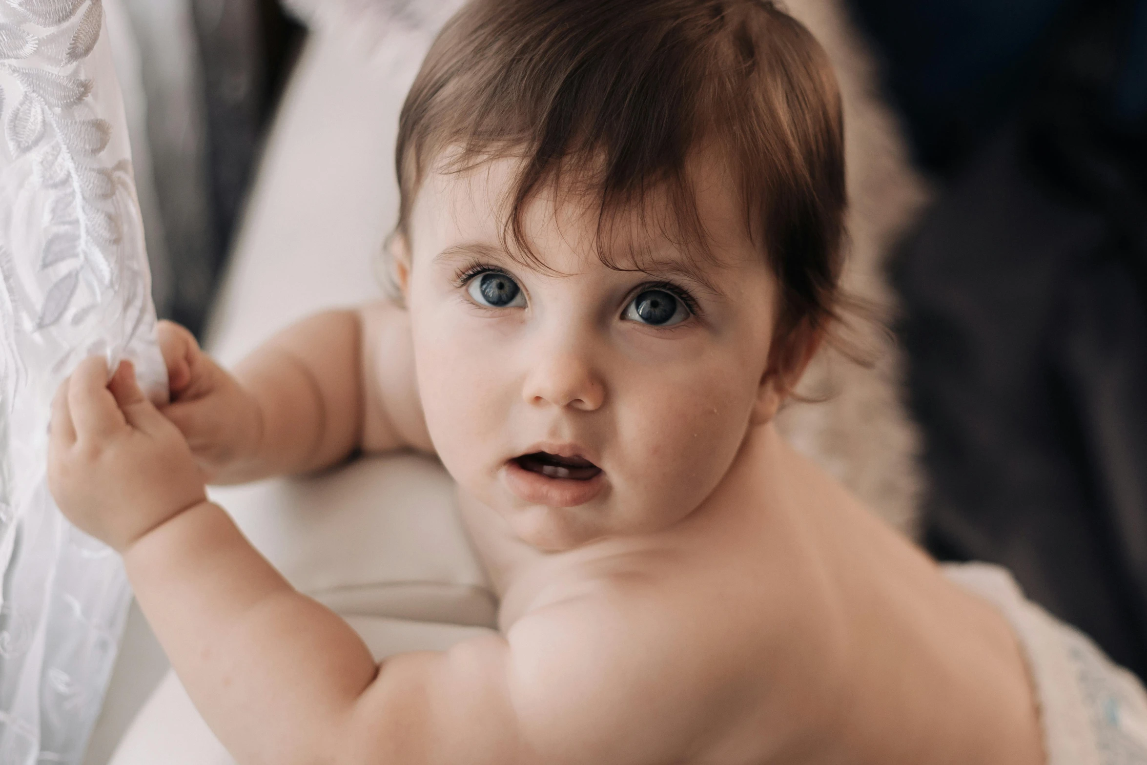 a baby in a diaper looking at the camera, pexels contest winner, bare shoulders, blue-eyed, bowater charlie and brom gerald, color photograph portrait 4k