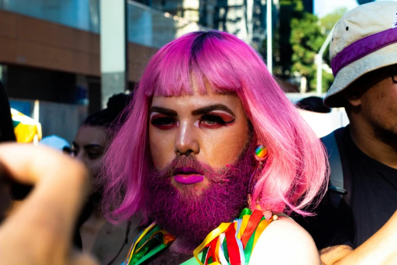 a man with pink hair and a beard, trending on pexels, pride parade, large bushy eyebrows, lachlan bailey, in sao paulo