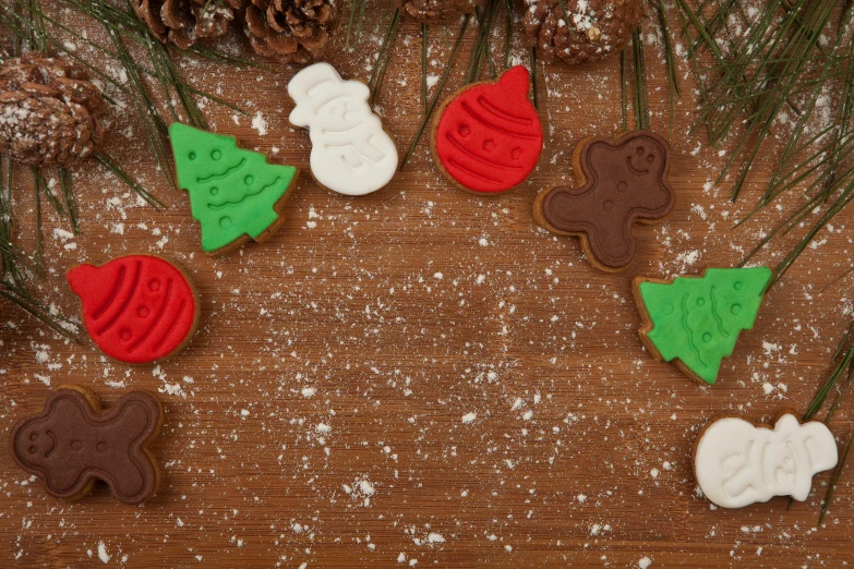a close up of some cookies on a table, a cartoon, inspired by Ernest William Christmas, pexels, evergreen branches, hand carved brown resin, background image, thumbnail