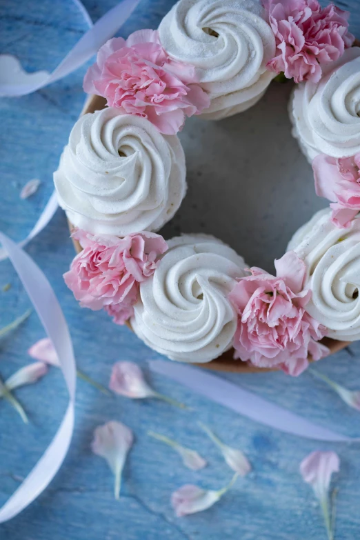 a cake with white frosting and pink flowers, featured on pinterest, whirlpool, detail shot, circle, no cropping