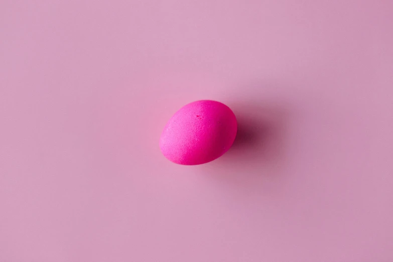 a pink egg sitting on top of a pink surface, trending on pexels, here is one olive, fluorescent colours, made of candy, 15081959 21121991 01012000 4k