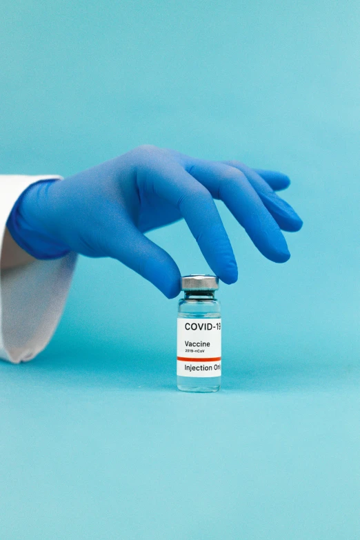 a gloved hand holding a vial of covidin, a picture, shutterstock, instagram photo, blue, manipulation, contain