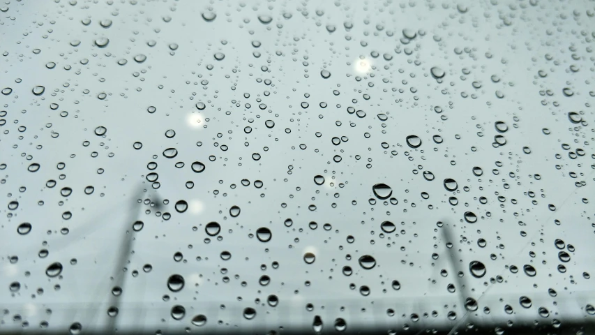 a close up of water droplets on a windshield, by Ryan Pancoast, visual art, rainy day. game render, up there, lights off, overcast gray skies