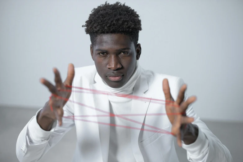 a man in a white shirt is holding his hands up, an album cover, by Lily Delissa Joseph, pexels contest winner, pulling strings, young thug, headshot photo, he is wearing a suit
