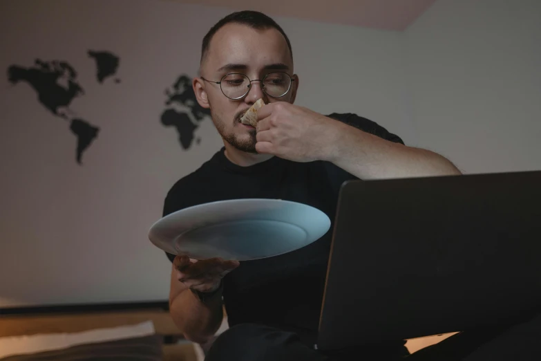 a man sitting in front of a laptop eating food, on a plate, best photo, 2019 trending photo, profile photo