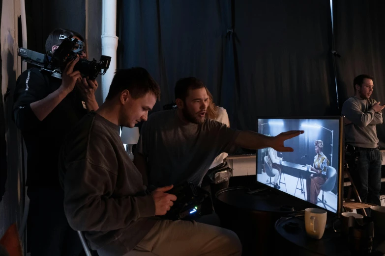 a group of men sitting in front of a tv, cinematography lighting, unreal engine. film still, mana shooting from his hands, tuomas korpi and wlop