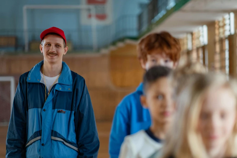 a group of people standing next to each other, a portrait, inspired by Wes Anderson, trending on pexels, fantastic realism, wearing a blue hoodie, worksafe. cinematic, male teenager, thumbnail