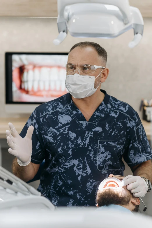 a man standing next to a woman in a dentist's chair, transparent labs, paul barson, wearing facemask, ultrawide image