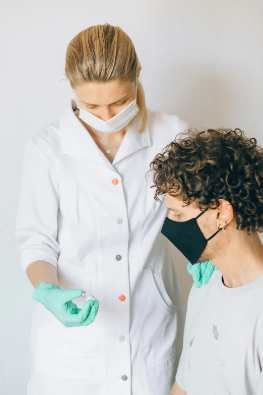a woman standing next to a man in a white lab coat, pexels, antipodeans, wearing gloves, masking, bumps, profile image