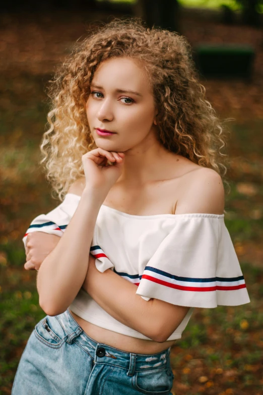a woman with curly hair posing for a picture, by Adam Marczyński, trending on pexels, renaissance, off the shoulder shirt, striped, 15081959 21121991 01012000 4k, portrait of white teenage girl