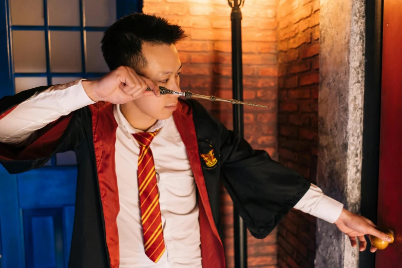 a man in a harry potter robe smoking a cigarette, pexels contest winner, louise zhang, wielding a magic staff, magical school student uniform, studio photo