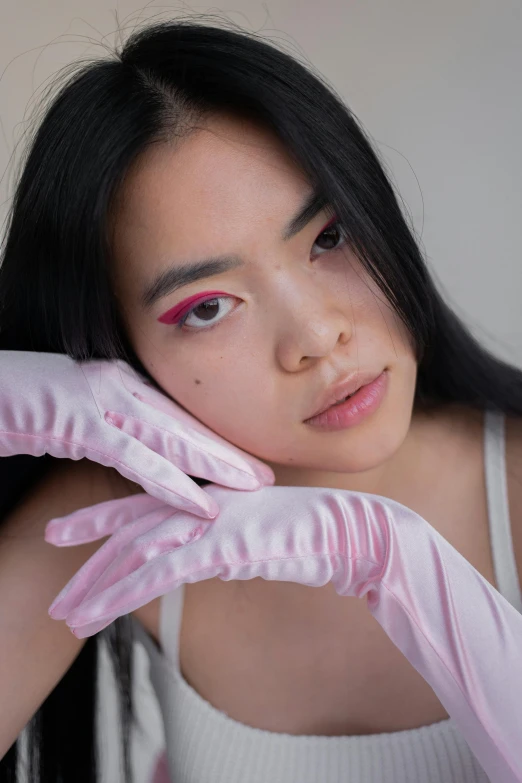 a woman with long black hair wearing pink gloves, inspired by Natasha Tan, set on singaporean aesthetic, white satin gloves, non binary model, close up at face