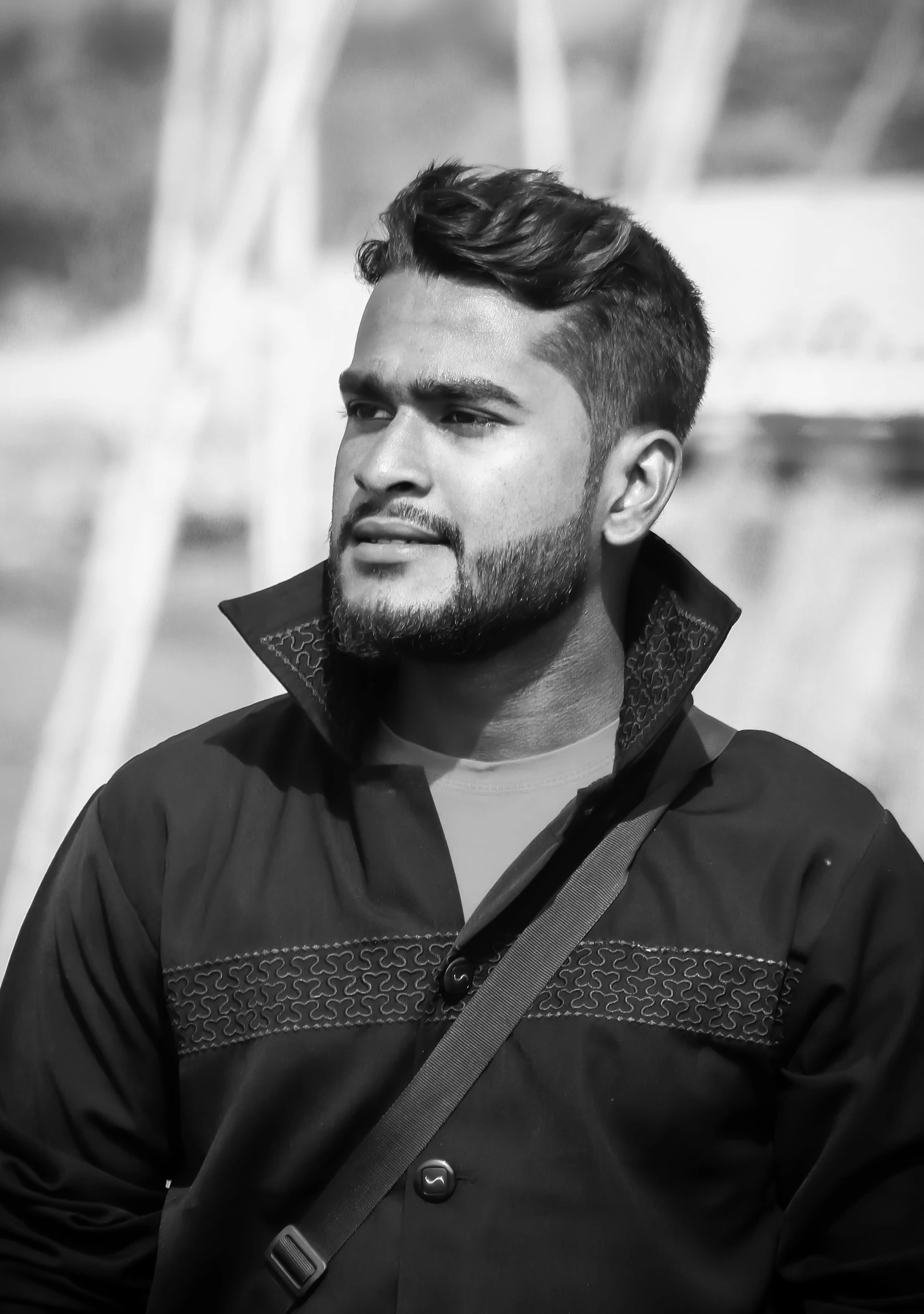 a man standing next to a body of water, a black and white photo, inspired by Saurabh Jethani, headshot profile picture, cute young man, selective color effect, looking at camera!!!