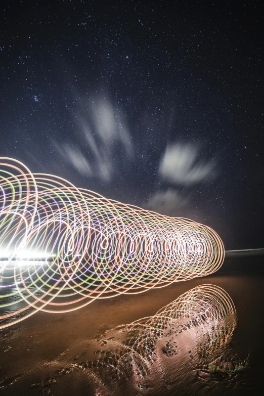 a long exposure photograph of a light painting on the beach, inspired by Bruce Munro, unsplash contest winner, light and space, traveling into a blackhole, deep space super structure, super long shot, intricate art photography