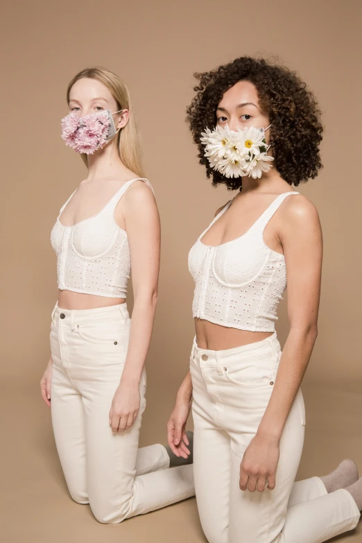 two women sitting on the ground with flowers in their mouths, by Dulah Marie Evans, trending on pexels, renaissance, made of lab tissue, croptop, wearing transparent glass mask, official product photo