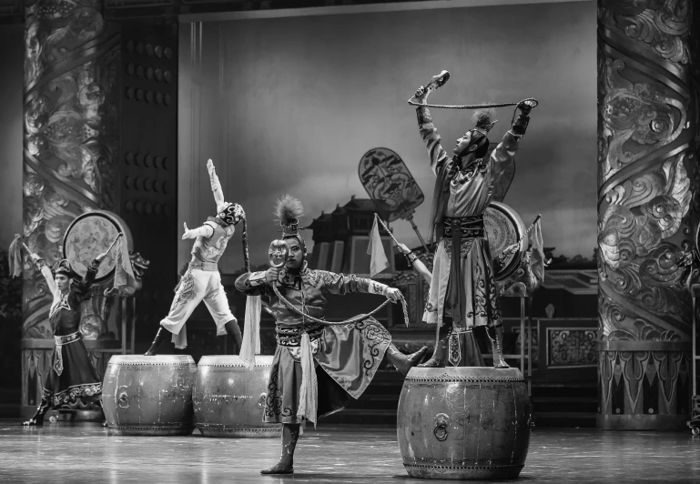 a group of men standing on top of a stage, a black and white photo, arabesque, chinese armor, barrels, ballet performance photography, monkey king