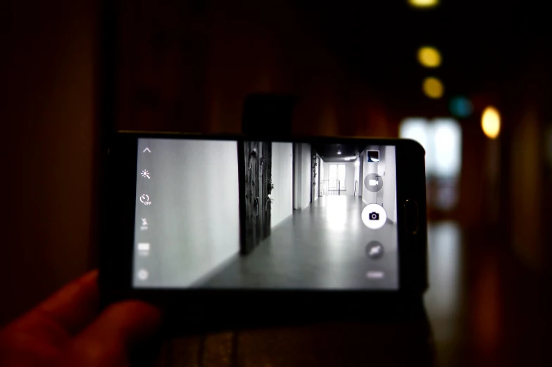 a person taking a picture with a cell phone, by Android Jones, realism, long exposure ; sharp focus, haunted liminal abandoned room, high school, close up to the screen