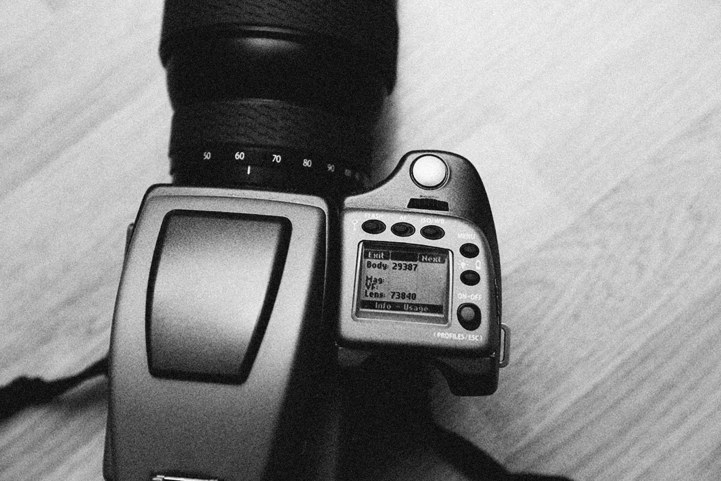 a black and white photo of a camera, by Romain brook, camera flash, hasselblade shot, high angle camera, lens blur