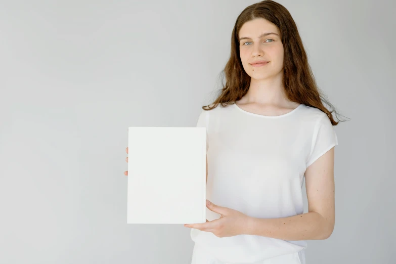 a woman in a white shirt holding a white sign, a minimalist painting, pexels contest winner, renaissance, smooth translucent white skin, portrait of small, white box, thin young male