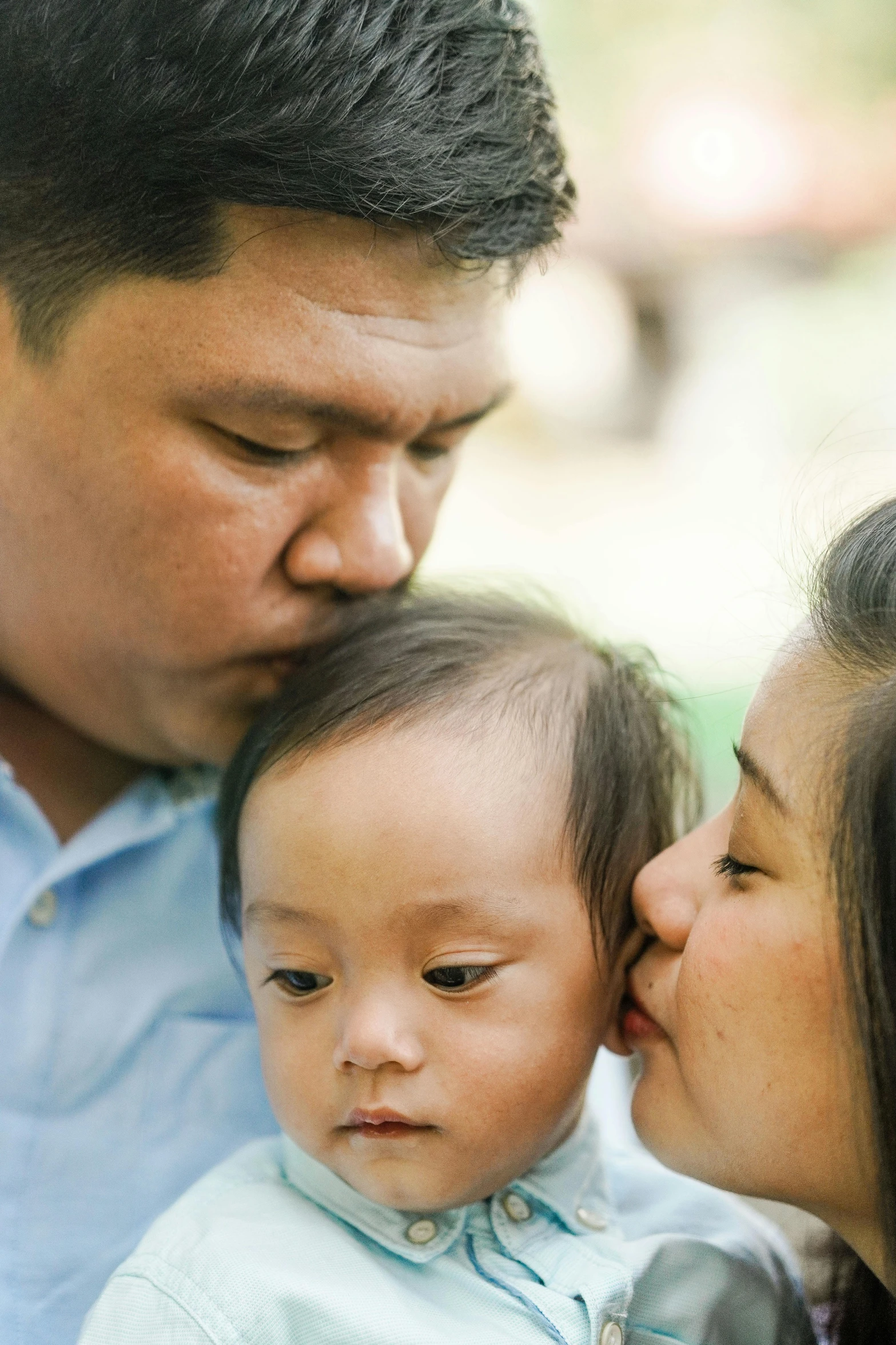 a man kissing a woman while holding a baby, unsplash, sumatraism, low detail, asian face, square, kids