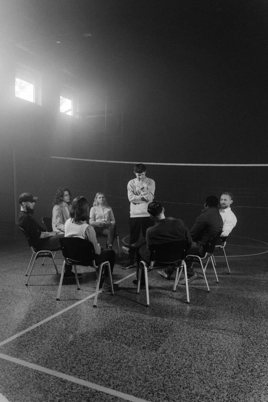 a group of people sitting around a tennis court, a black and white photo, pexels contest winner, realism, in a black empty studio hollow, conversation pit, volleyball, ( ( theatrical ) )