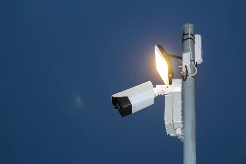 a close up of a street light on a pole, unsplash, security cam video, lit from the side, photographed for reuters, 3 2 megapixel