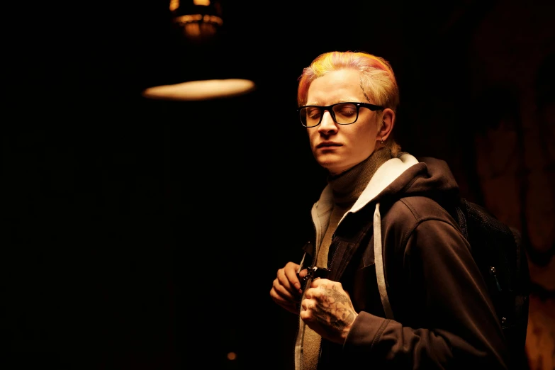 a man with red hair and glasses standing in a dark room, albino hair, in style of kar wai wong, cinestill colour, eminem