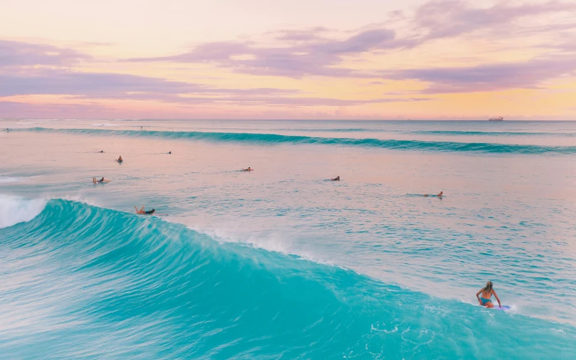 a group of people riding waves on top of surfboards, unsplash contest winner, minimalism, turquoise and pink lighting, australian beach, lined up horizontally, iridescent shimmering pools