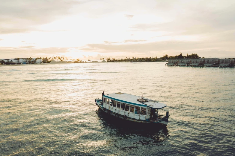 a boat floating on top of a body of water, happening, manly, afternoon hangout, hoang lap, (golden hour)