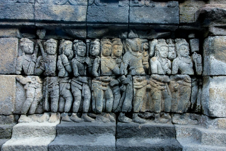 a group of statues sitting on top of a stone wall, visual art, indonesia, avatar image, intricately carved, thumbnail