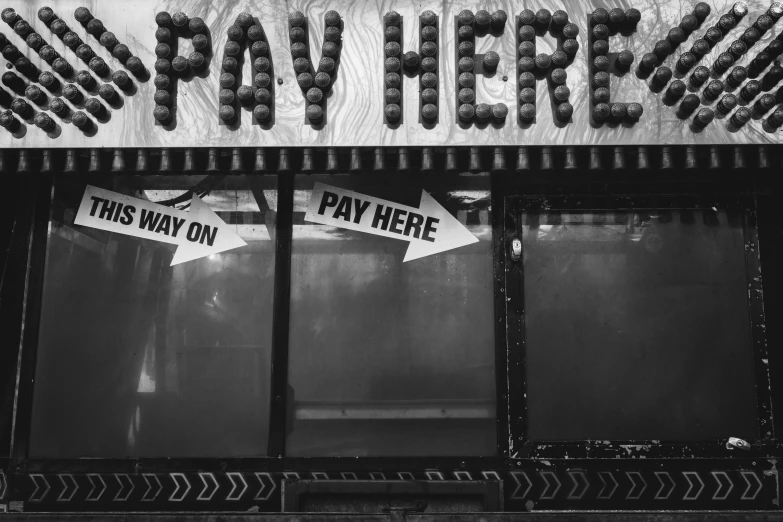 a black and white photo of a pay here sign, by Byron Galvez, pexels, fine art, fruit machines, 1 6 x 1 6, food stall, untitled