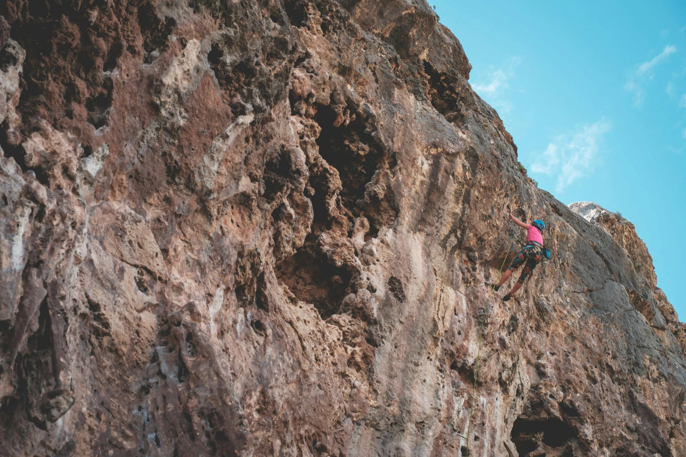 a person climbing up the side of a mountain, pexels contest winner, figuration libre, pink, brown, “diamonds, avatar image