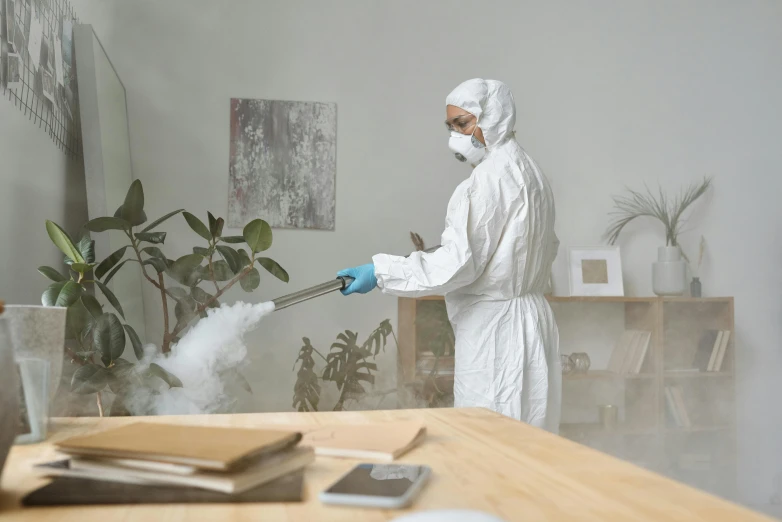 a person in a white suit spraying something with a hose, sterile minimalistic room, avatar image, professional photograph, furniture