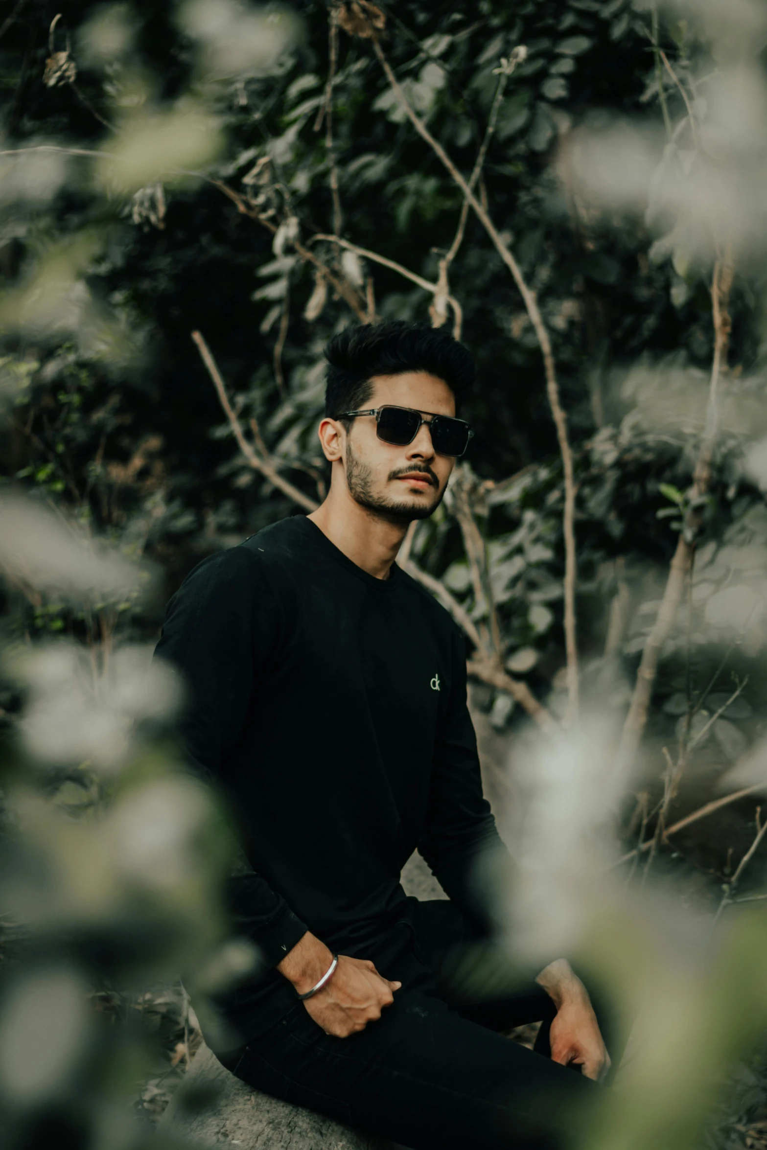 a man sitting on a rock in the woods, pexels contest winner, wearing shades, wearing black tshirt, jayison devadas, profile image