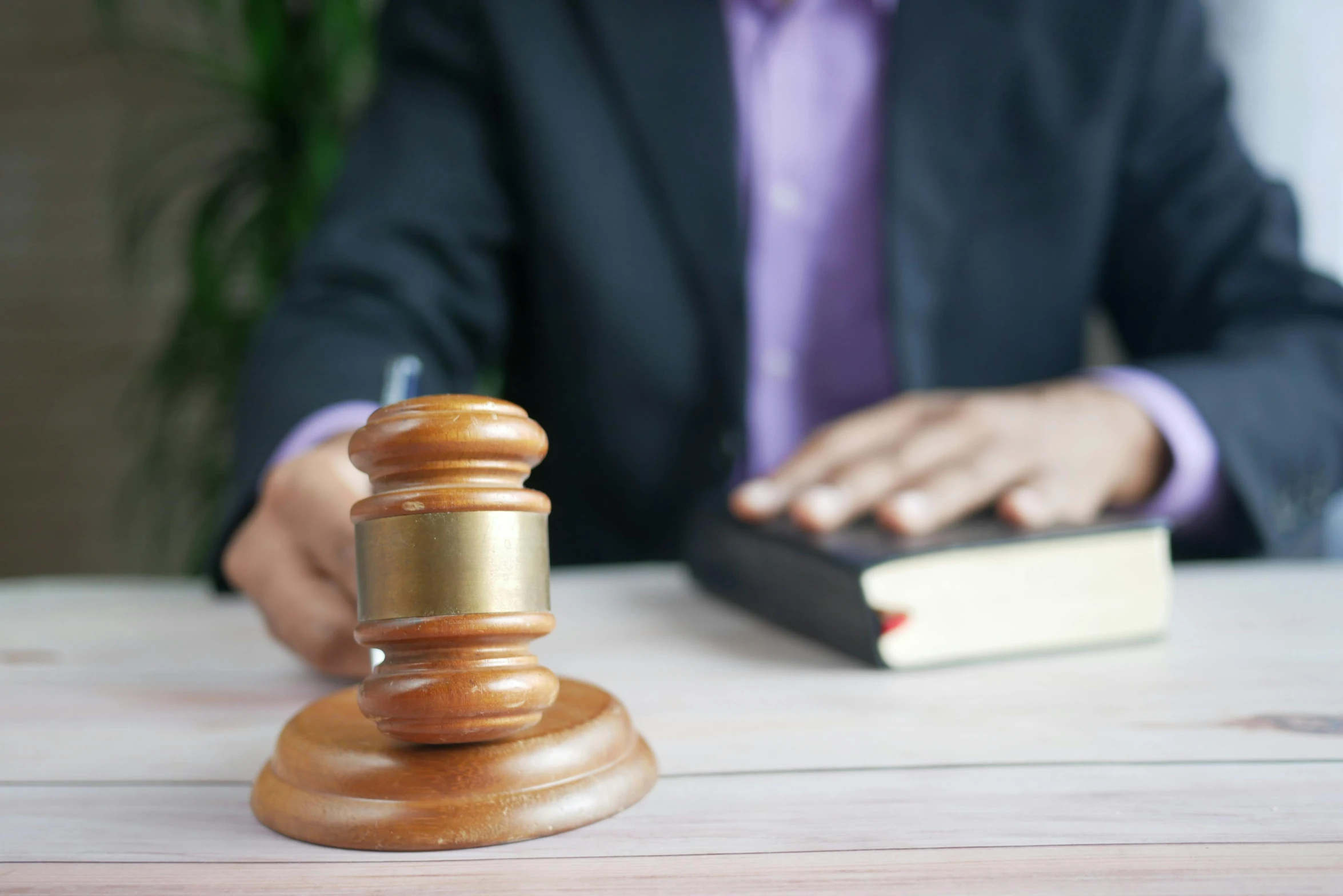 a man in a suit sitting at a table with a gavel, court images, thumbnail